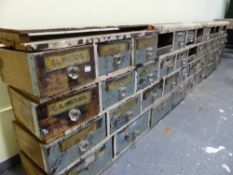 AN IMPRESSIVE BARN FIND RUN OF THIRTY EIGHT APOTHECARY DRAWERS, SOME WITH ORIGINAL LABELS. W.275 x