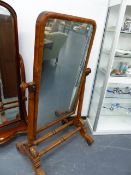 A VICTORIAN MAHOGANY CHEVAL MIRROR ON SHAPED LEGS UNITED BY DOUBLE STRETCHERS, MIRROR 68 x 121cms.