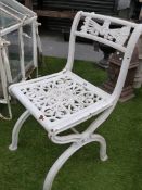 A SET OF FOUR VINTAGE CAST IRON GARDEN CHAIRS ON X-FORM BASES WITH FIST OF SIX ARROWS CREST