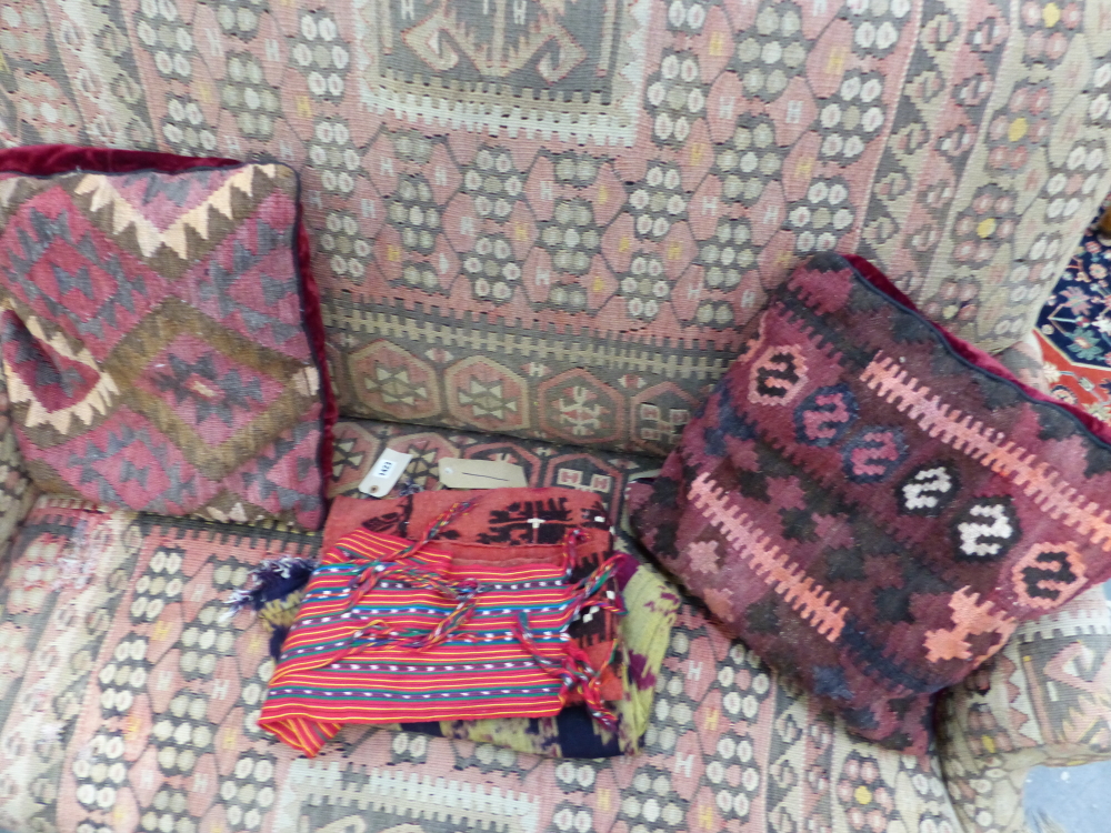 TWO KELIM COVERED CUSHIONS TOGETHER WITH VARIOUS TRIBAL TEXTILES TO INCLUDE AN IKAT PANEL. - Image 2 of 5