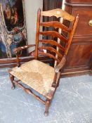 A 19th.C.ASH LADDER BACK COTTAGE ARMCHAIR WITH RUSH SEAT.