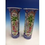 A PAIR OF JAPANESE FAMILLE ROSE SLEEVE VASES PAINTED WITH BLUE FRAMED PANELS OF LADIES AND