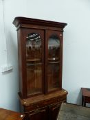 A VICTORIAN MAHOGANY GLAZED TOP BOOKCASE WITH TWO DRAWERS AND PANEL BASE DOORS ON PLINTH BASE. 95