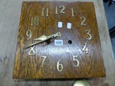 AN ARTS AND CRAFTS OAK CASED STRIKING WALL CLOCK WITH BRASS NUMERALS. 32 x 32cms.