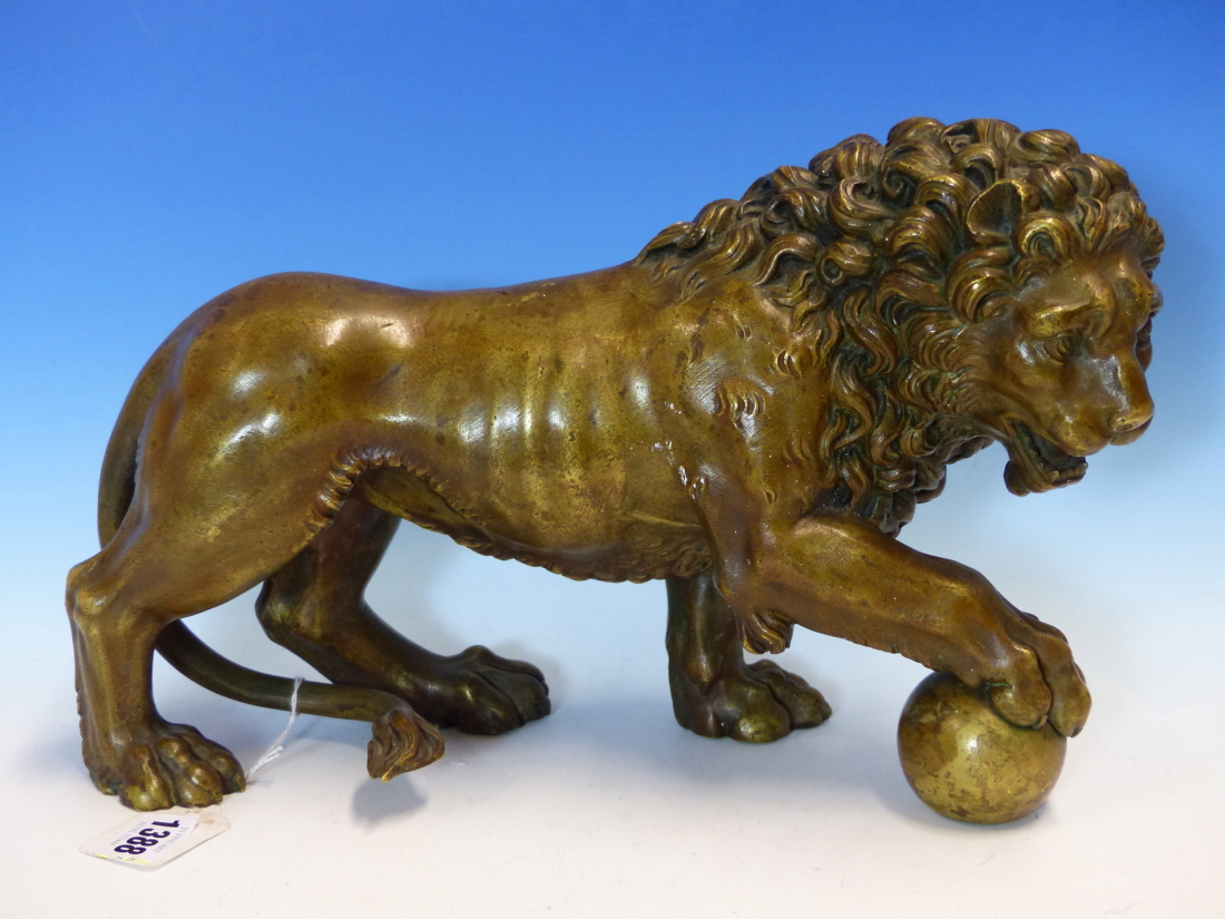 AFTER THE MEDICI LION, A BRONZE FIGURE GROWLING AND WITH RIGHT FOREPAW RAISED ON A BALL. W 35cms.