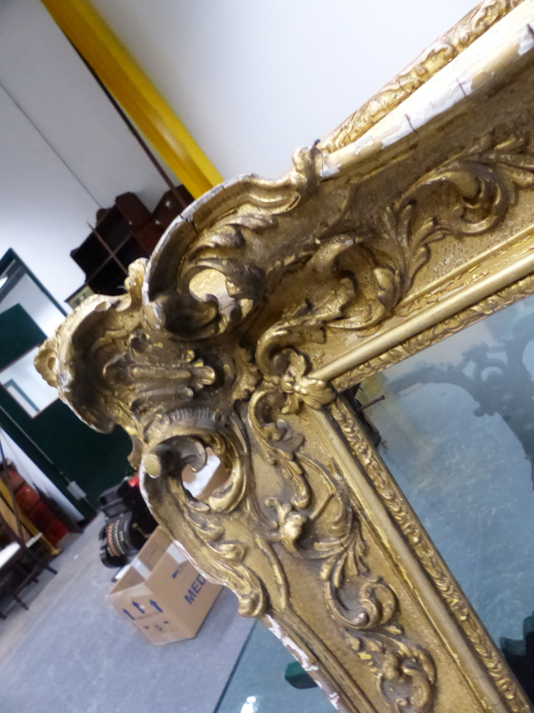 A LARGE VICTORIAN SWEPT GILT PICTURE FRAME IN THE FRENCH STYLE. REBATE 69 x 99.5cms. - Image 5 of 8