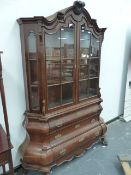 A DUTCH WALNUT SIDE CABINET WITH ARCH TOP, TWIN GLAZED PANEL DOORS OVER BOMBE THREE DRAWER BASE ON