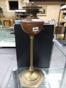 A BRASS COLUMN OIL LAMP by W.A.S BENSON WITH HEXAGONAL FOOT AND COPPER RECEIVER. H 54cms.