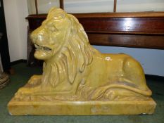 A PAIR OF LARGE ANTIQUE SCOTTISH PAISLEY POTTERY FIGURES OF RECUMBENT LIONS ON PLINTH BASES.