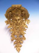 A PAIR OF FRENCH ORMOLU WALL BRACKETS, THE HALF ROUND SHELVES ABOVE HIRSUTE SATYR MASKS AMONGST