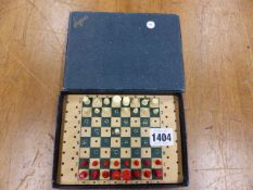 A JACQUES CARD BOARD BOXED RED AND WHITE PLASTIC TRAVELLING CHESS SET, THE BOX. W 16 X D 12cms