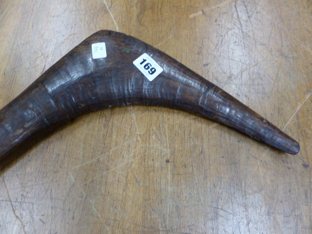 AN ABORIGINAL CLUB, THE LAPPET CARVED HANDLE WITH PINE CONE POMMEL, THE HEAD AT RIGHT ANGLES TO