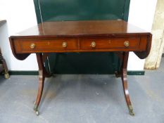 A GEORGIAN INLAID MAHOGANY SOFA TABLE WITH APRON DRAWERS ON BRASS CAP CASTERS.