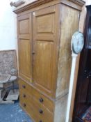 A 19th.C.PINE HOUSEKEEPER'S CABINET WITH PAIR OF FIELDED PANEL DOORS OVER THREE LONG DRAWERS. 107