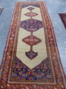 AN ANTIQUE PERSIAN SERAB RUNNER. 293 x 113cms.