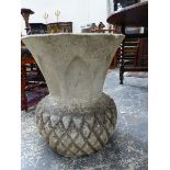 A COMPOSITE STONE GARDEN URN OF STYLISED PINEAPPLE FORM AND A SIMILAR URN WITH VINE DECORATION. H.