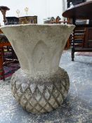 A COMPOSITE STONE GARDEN URN OF STYLISED PINEAPPLE FORM AND A SIMILAR URN WITH VINE DECORATION. H.