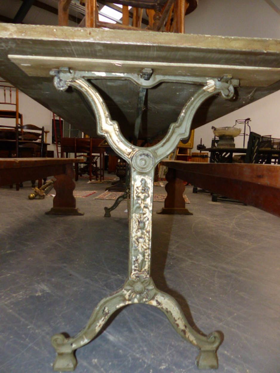 A SET OF THREE CAST IRON BASED TABLES WITH CAST IRON TRESTLE BASES AND ZINC WRAPPED TOPS. 69 x 210 x - Image 7 of 11