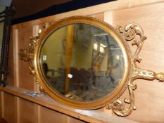 A 19th.C.OVAL MIRROR WITH GILT FOLIATE CREST AND BASE. 104 x 52cms.