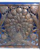 A COPPER PANEL PIERCED AND WORKED WITH A PEACOCK DISPLAYING, PREVIOUSLY ATTRIBUTED TO C R ASHBEE.