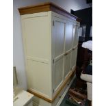 A MODERN OAK AND PAINTED PANELLED TRIPLE WARDROBE WITH A TWO DRAWER BASE AND SHAPED PLINTH. 172 x 60