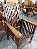 NAVAL INTEREST. AN ARTS AND CRAFTS PERIOD TEAK RECLINING ARMCHAIR MADE FROM TIMBER OF H.M.S. REKNOWN