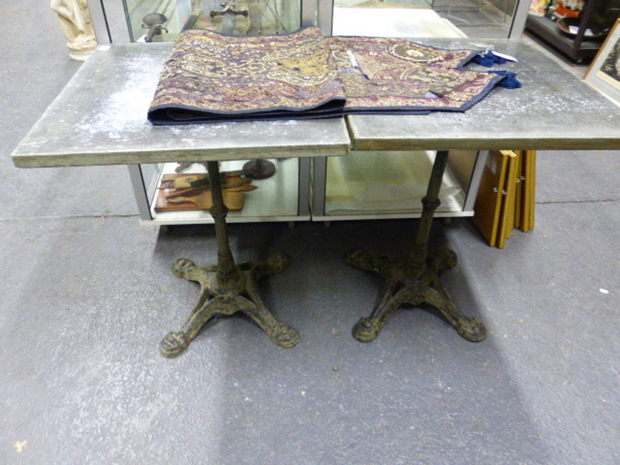 A PAIR OF VINTAGE CAFE TABLES WITH CAST IRON BASES AND ZINC WRAPPED PINE TOPS. 59 x 59 x H.73cms. - Image 2 of 8