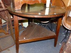 AN 18th.C.OAK CRICKET TABLE WITH CIRCULAR TOP OVER TRIANGULAR SECTION LEGS UNITED BY UNDERTIER.