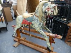 AN EARLY 20th.C.ROCKING HORSE ON TRESTLE BASE. HOOF TO EAR 74cms.