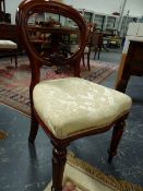 A SET OF SIX VICTORIAN MAHOGANY BALLOON BACK DINING CHAIRS ON BROAD REEDED FORELEGS. (6)