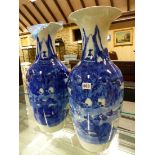 A PAIR OF JAPANESE BLUE AND WHITE BALUSTER VASES PAINTED WITH MOUNTAINOUS ISLAND LANDSCAPES. H