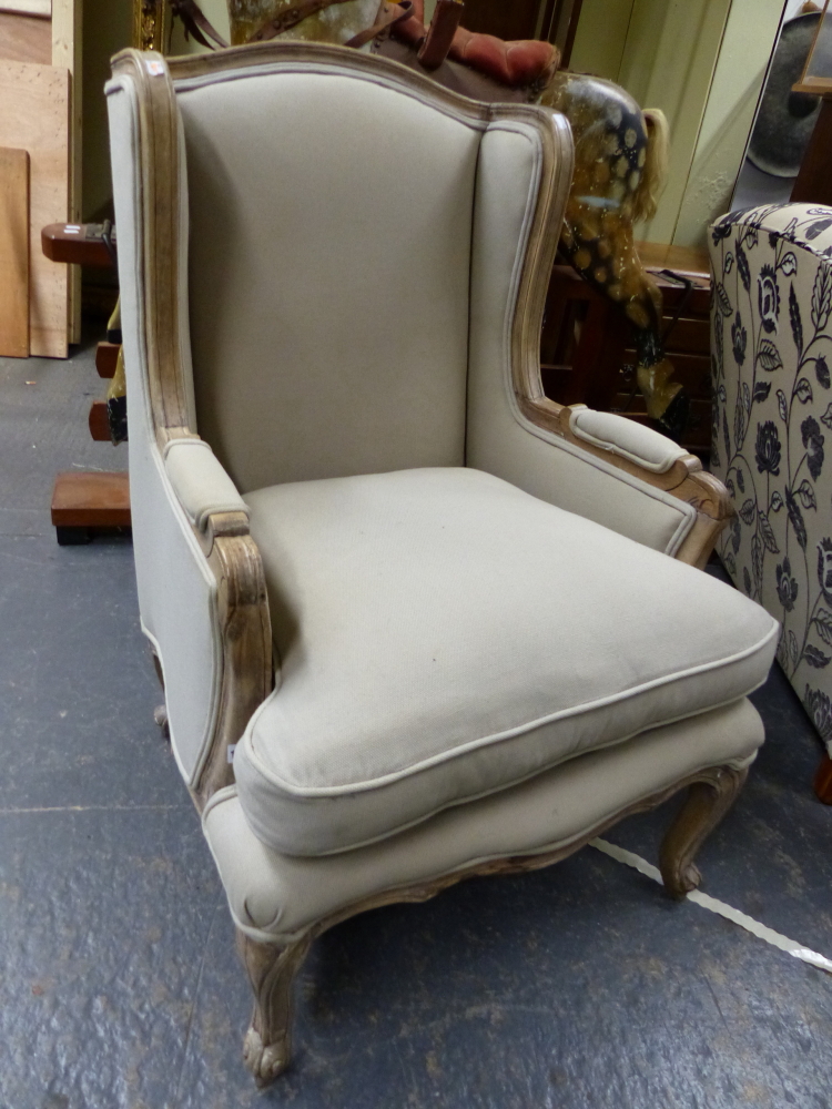 A LOUIS XV.STYLE BLEACHED WALNUT SHOW FRAME ARMCHAIR WITH LOOSE SQUAB CUSHION.