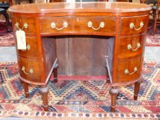 AN EARLY 20th.C.MAHOGANY KIDNEY FORM KNEEHOLE DESK WITH SEVEN DRAWERS ON CARVED AND TURNED LEGS.