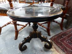 A PAIR OF REGENCY STYLE TRIPOD TABLES WITH DISHED TOPS ON SHAPED TRIPOD SUPPORTS WITH EBONISED AND