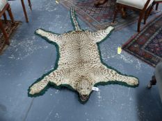 TAXIDERMY. A JUVENILE LEOPARD SKIN RUG WITH FELT BACKING.