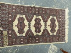 AN ORIENTAL RUG OF BOKHARA DESIGN. 148 x 88cms TOGETHER WITH A SIMILAR MAT. (2)