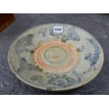 A PROVINCIAL CHINESE BLUE AND WHITE DISH RECOVERED FROM A SHIPWRECK CARGO, PAINTED WITH FISH