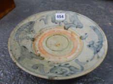 A PROVINCIAL CHINESE BLUE AND WHITE DISH RECOVERED FROM A SHIPWRECK CARGO, PAINTED WITH FISH