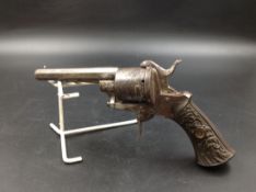 AN EIG RIM FIRE SIX SHOT REVOLVER WITH FOLDING TRIGGER, OCTAGONAL BARREL AND BAKELITE HANDLE MOULDED