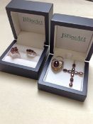 A 9ct GOLD GARNET SET CROSS PENDANT TOGETHER WITH TWO GARNET SET 9ct GOLD RINGS,FINGER SIZE I 1/2