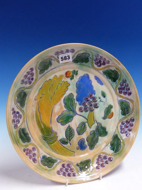 A DOULTON BRANGWYN WARE DISH WITH A WAVY BAND OF GRAPE VINES ENCLOSING A WHEATSHEAF, GRAPES AND