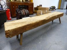 AN ANTIQUE OAK BEAM MOUNTED ON PEG LEGS AS A COFFEE TABLE. 175 x 27 x H.32cms.