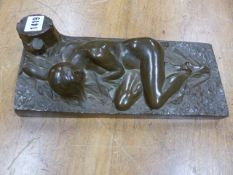 A COLD CAST BRONZE NUDE RECLINING ON A SHEET BY A TREE STUMP, BEARS SIGNATURE R