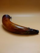 A POWDER HORN MOUNTED WITH SUSPENSION RINGS AT EACH END. W 30cms.