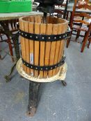 A CIDERMAKER'S FRUIT CRUSHER AND A CAST IRON APPLE PRESS.