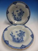A PAIR OF ENGLISH DELFT BLUE AND WHITE SOUP PLATES CENTRALLY PAINTED WITH TWO BIRDS ABOUT CHERRY
