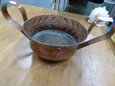 A KESWICK SCHOOL OF INDUSTRIAL ART TWO HANDLED COPPER BOWL, THE CAVETTO BELOW THE ROLLED OVER RIM