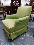 A VICTORIAN SMALL HOWARD STYLE ARMCHAIR ON SQUARE SHAPED FORELEGS AND BRASS CASTERS.