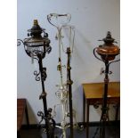 FOUR LATE 19th.C.WROUGHT IRON AND BRASS STANDARD LAMPS. (4)