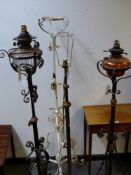 FOUR LATE 19th.C.WROUGHT IRON AND BRASS STANDARD LAMPS. (4)